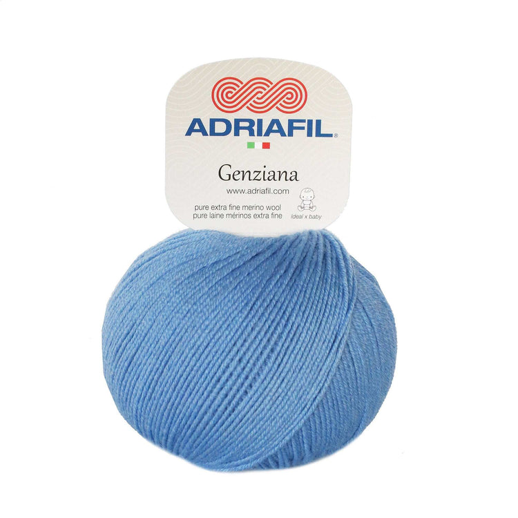 Gomitolo di lana merino extrafine azzurra, tinta unita, con etichetta Genziana e filato dalla torsione uniforme